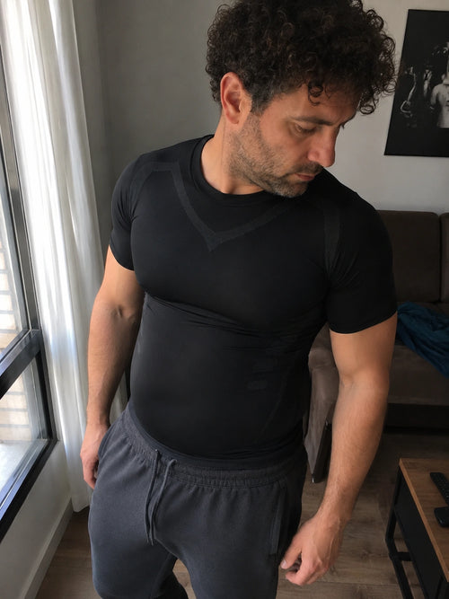 DEFYNMEN compression undershirt worn in an everyday setting